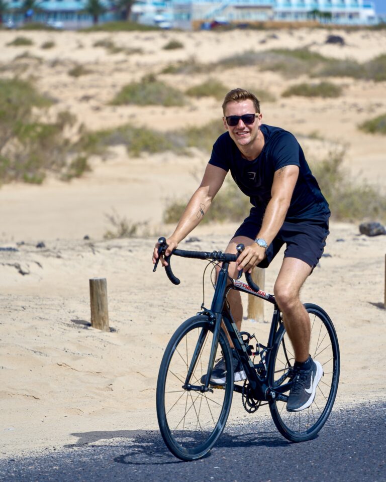 Max Haase on a bicycle with a NOMOS watch