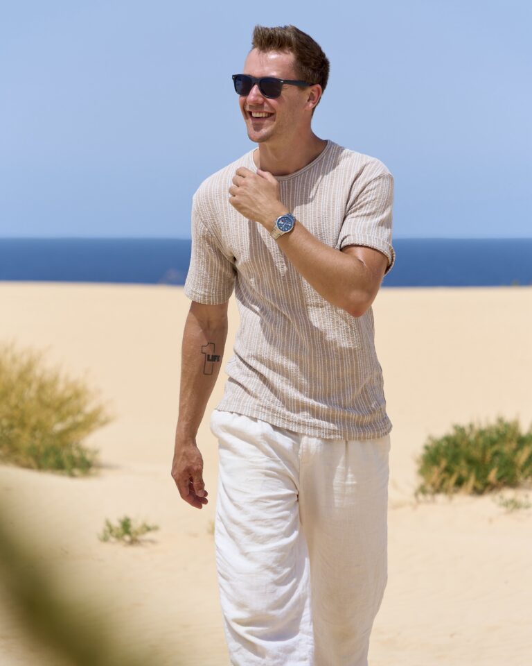 Max Haase in the desert landscape with a NOMOS watch