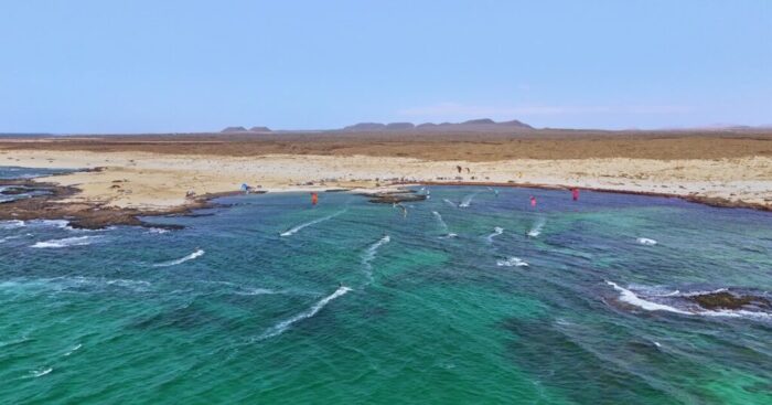 Kitesurfer on turquoise water off the coast of Fuerteventura - drone footage