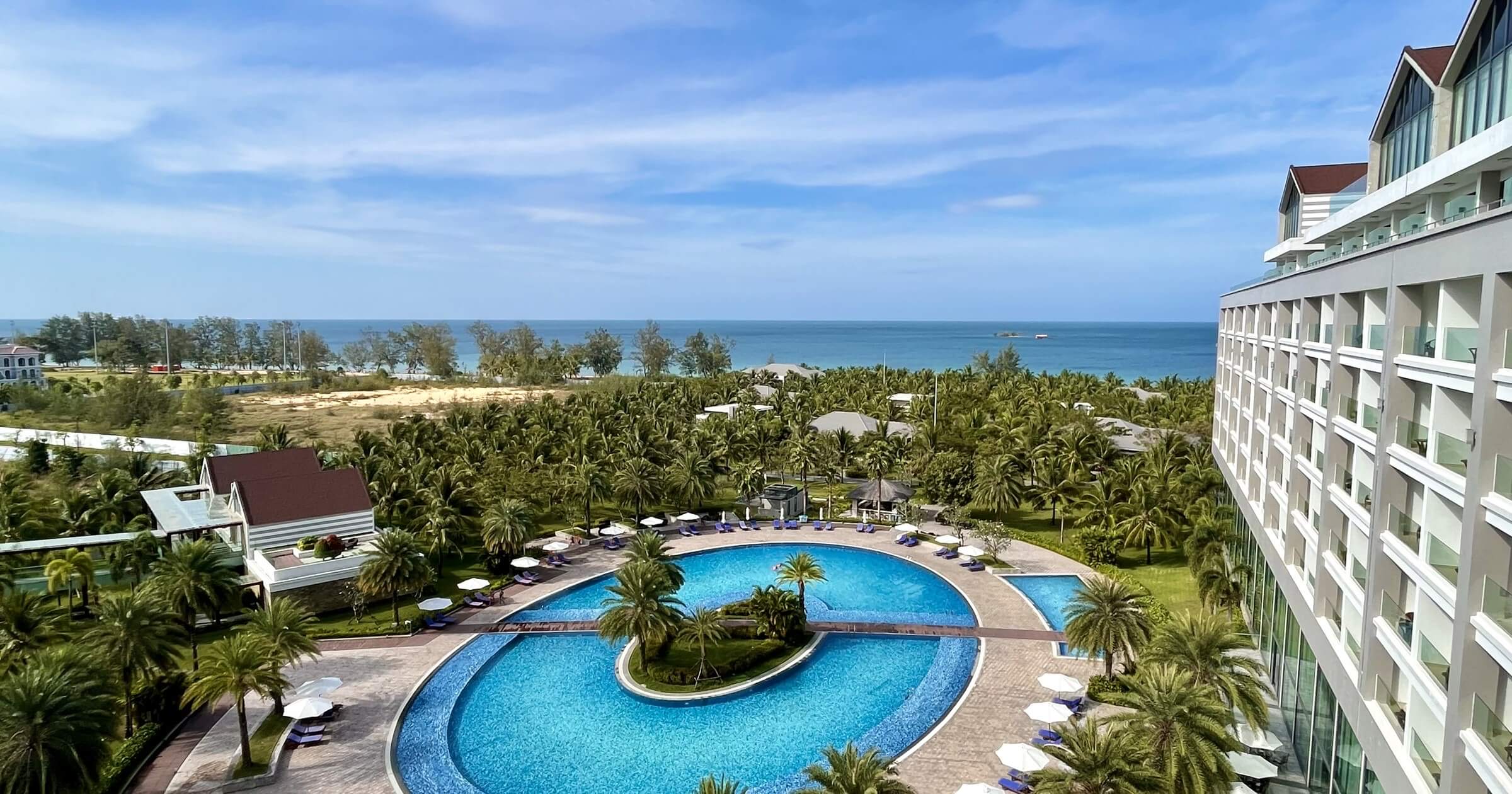 Pool area of a resort with sea views