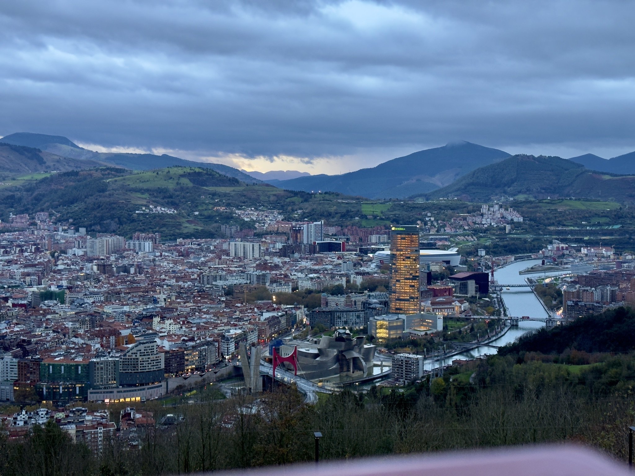 Panorama von Bilbao in der Dämmerung mit Ría, Torre Iberdrola und Hügeln