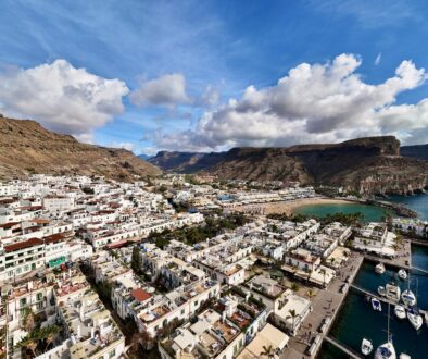Aerial view of Puerto de Mogán on Gran Canaria with white houses, marina and barren mountains