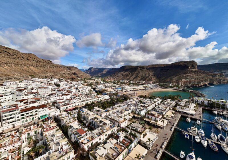 Aerial view of Puerto de Mogán on Gran Canaria with white houses, marina and barren mountains